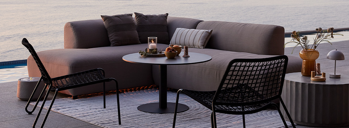 Baštenska lounge sofa za sve vremenske prilike koja se brzo suši i baštenske lounge stolice na terasi pri zalasku sunca
