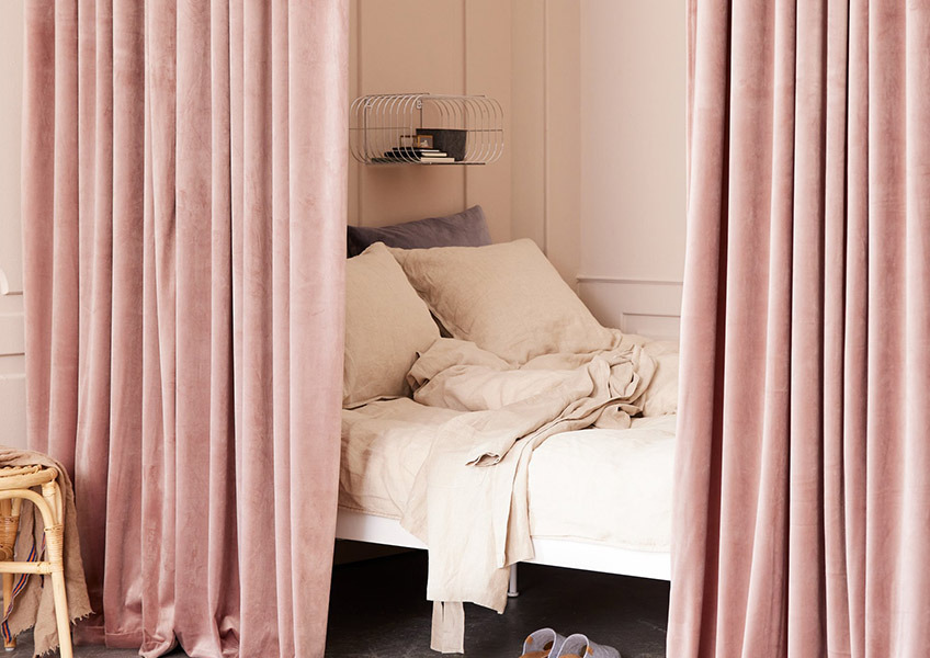 Guste roze zavese oko kreveta u spavaćoj sobi