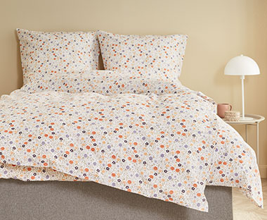 Šareni set posteljine u spavaćoj sobi krem zidova